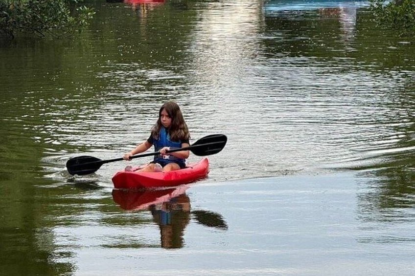 A person kayaking on calm water. 4