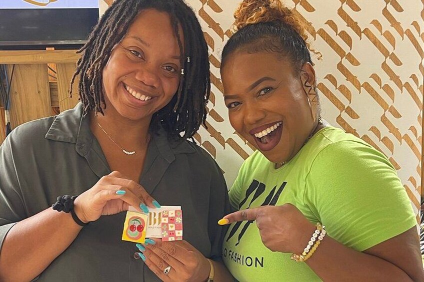 Two people holding a card with a colorful design. 5