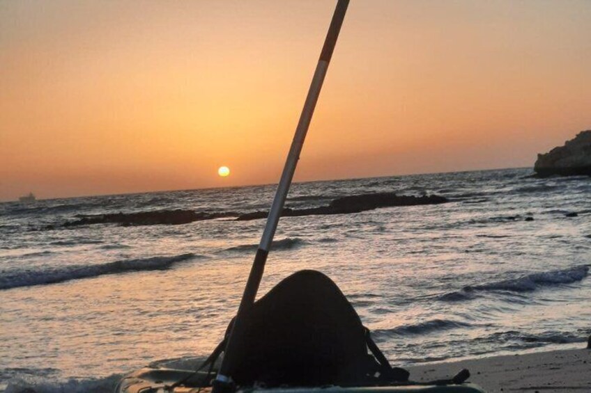 A sunset over the ocean with a boat's mast in the foreground. 5