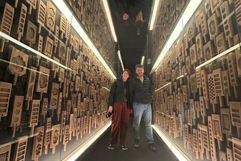 A corridor lined with wooden architectural models. 2