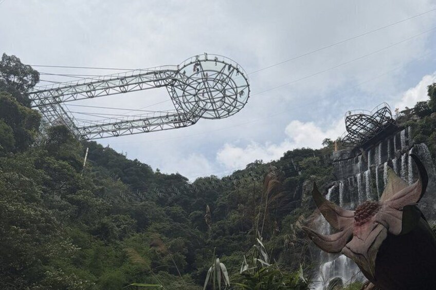 A waterfall, a large metal structure, and a sculpture. 2