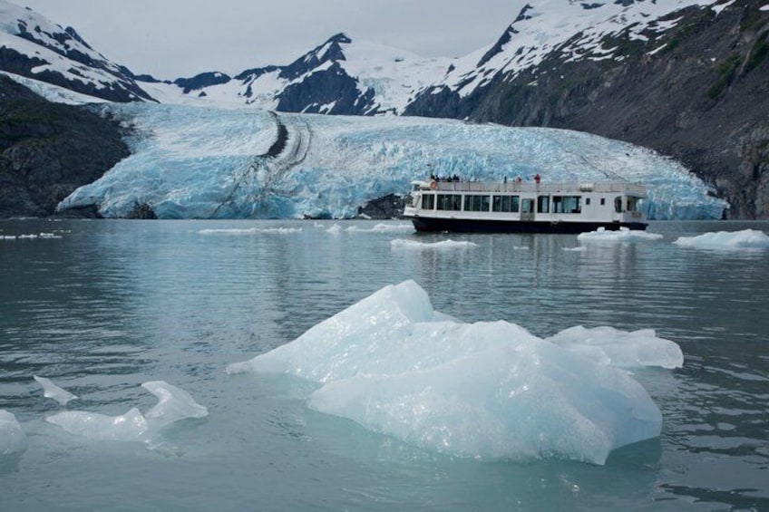 A glacier with a boat in the foreground. 3