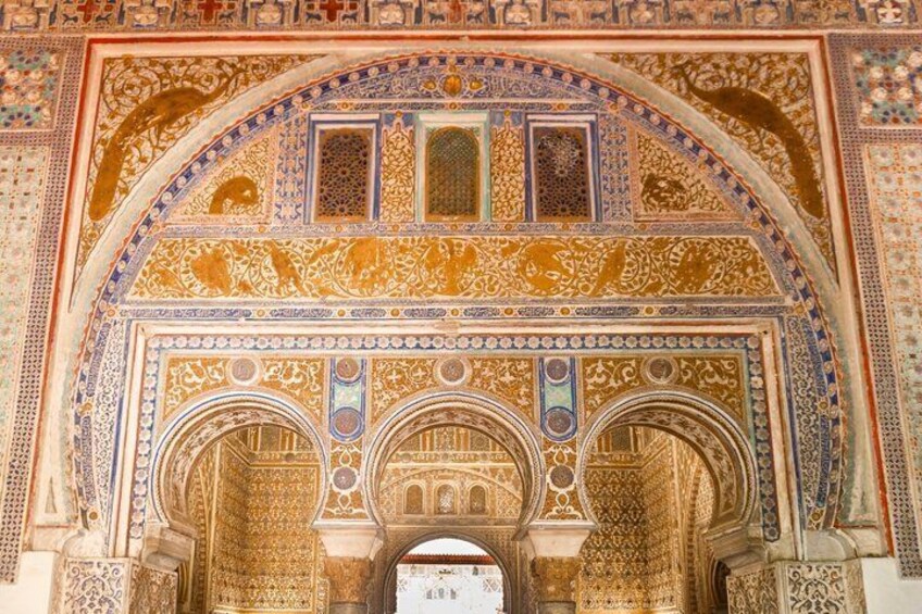 An ornate archway with intricate tile work and three arches. 2