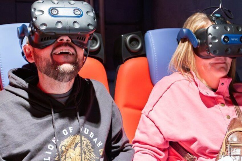 Two people wearing VR headsets. 1