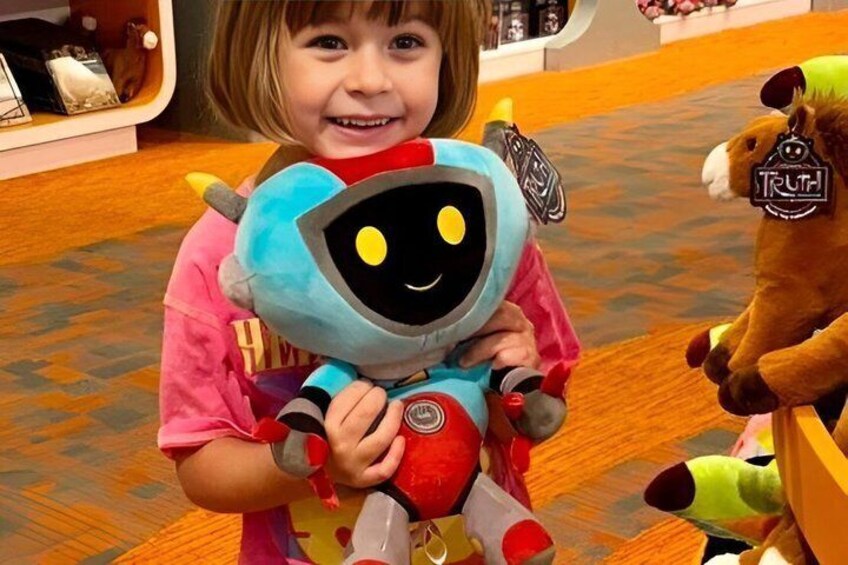 A child holding a blue and red plush toy. 2