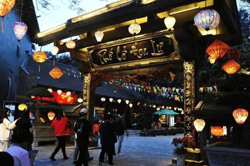 A traditional gate with ornate decorations and hanging lanterns. 3