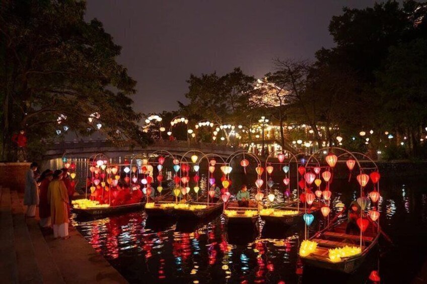 Illuminated boats with lanterns on a water body at night. 2