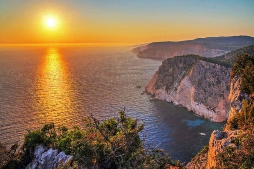 A coastal sunset with cliffs and a clear sky. 1