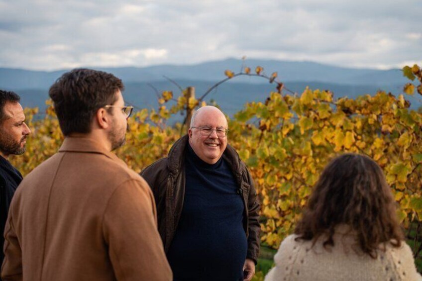 A group of people standing outdoors with a mountainous backdrop. 1