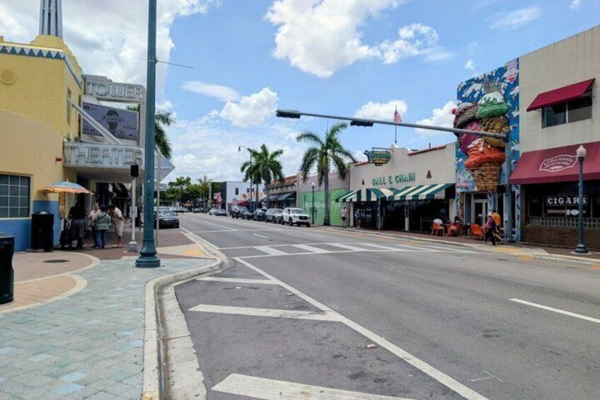 A street with a theater, a restaurant, and a cigar store. 3