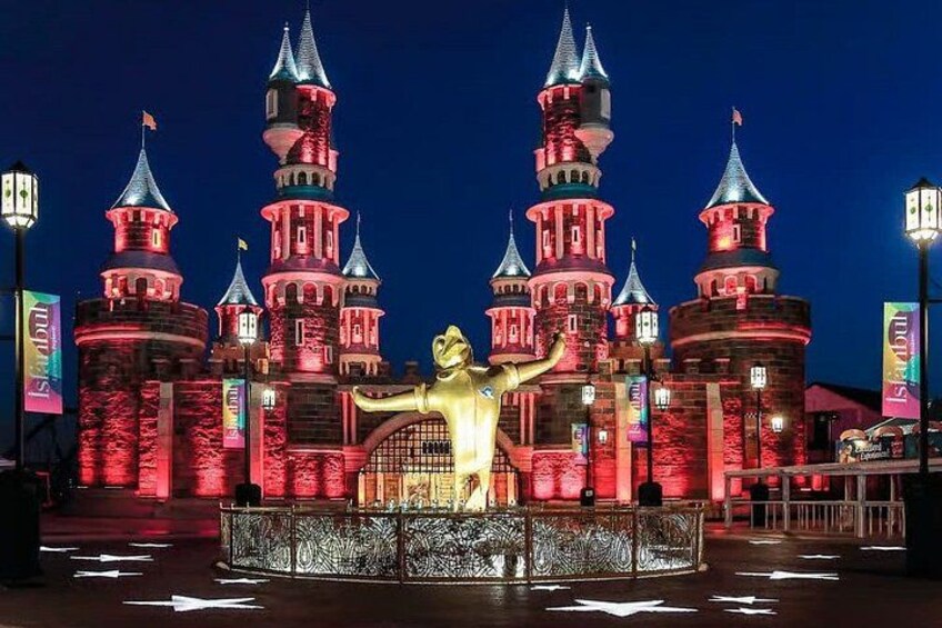 A castle-like structure with multiple towers and a golden statue in front. 2