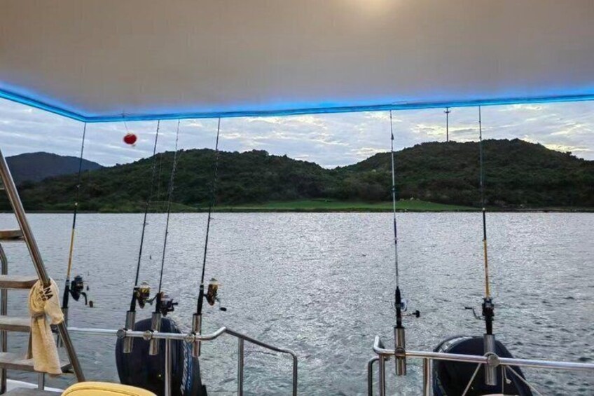 A boat with fishing rods, a ladder, and a rope. 2