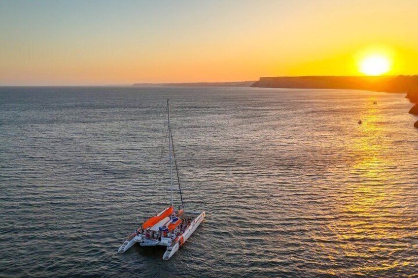 A boat on calm water during sunset with a clear sky. 4