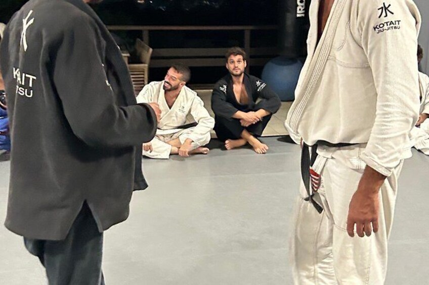 A martial arts training session with individuals in traditional gi uniforms. 3