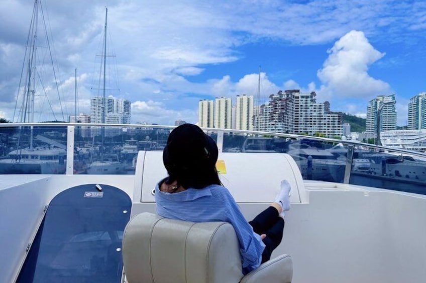 A person on a boat with a city skyline in the background. 4