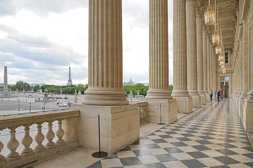 A grand architectural structure with large columns and a checkered floor. 3