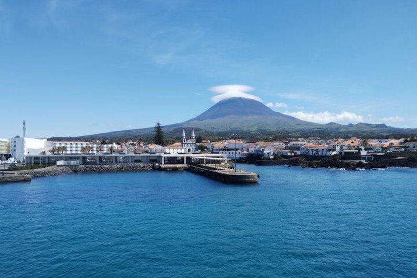 A coastal town with a prominent mountain in the background. 4