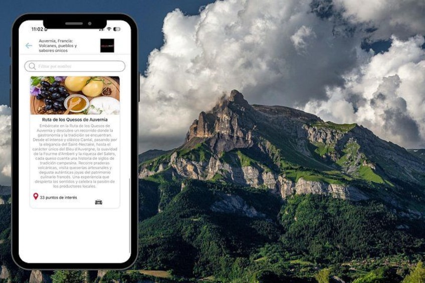 A smartphone displaying a travel article about the Ruta de los Quesos de Auvernia with a mountainous landscape in the background. 4