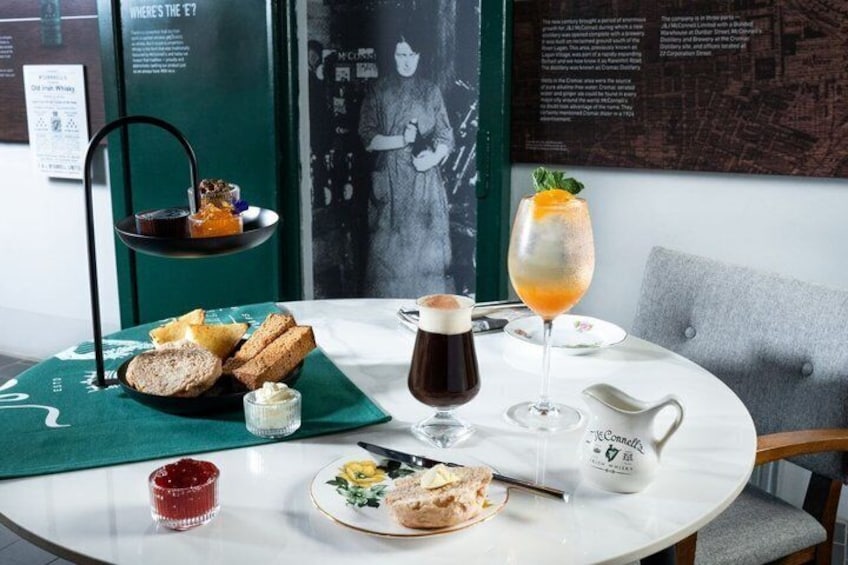 A table with a drink, bread, and a teapot. 1