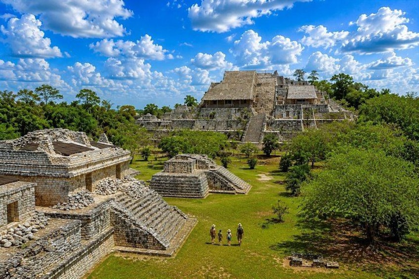 Ancient Mayan ruins with stepped pyramids and a large temple. 1