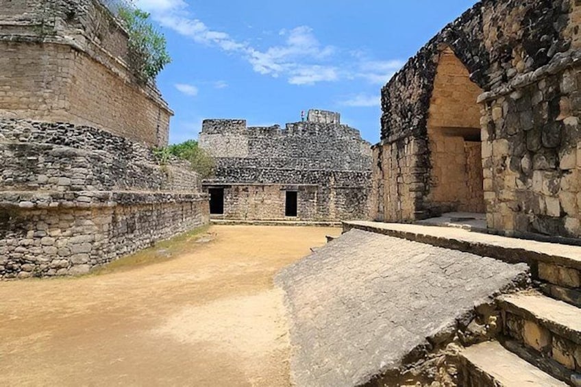 Ancient stone ruins with stepped platforms and a large central structure. 2