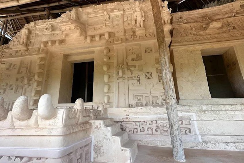 A detailed stone structure with carvings and steps. 3