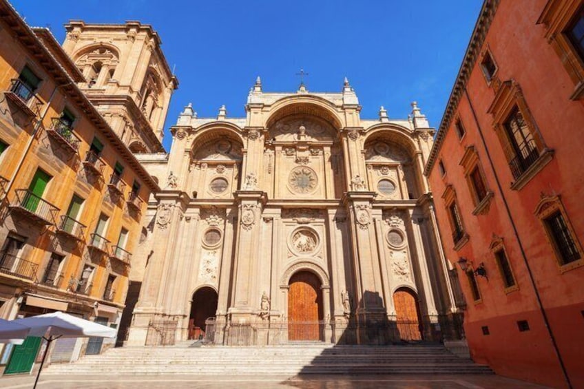 A grand cathedral with ornate architecture, a large clock, and a set of stairs leading to the entrance. 5
