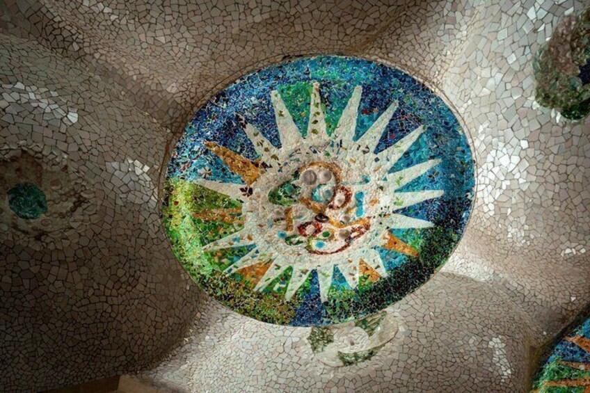 A mosaic ceiling with a central circular design and radiating patterns. 4