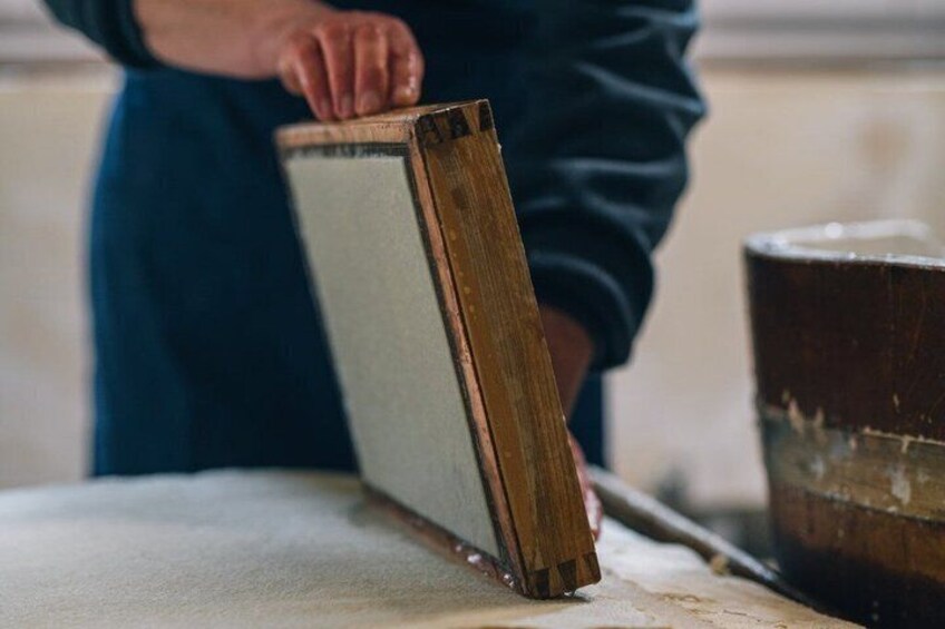 A person holding a wooden board. 1