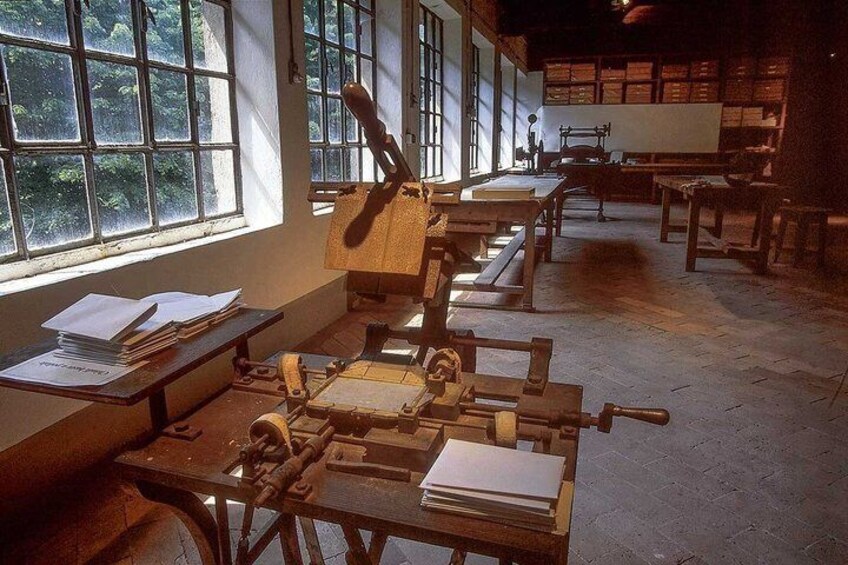 A classroom with desks, books, and a large window. 4