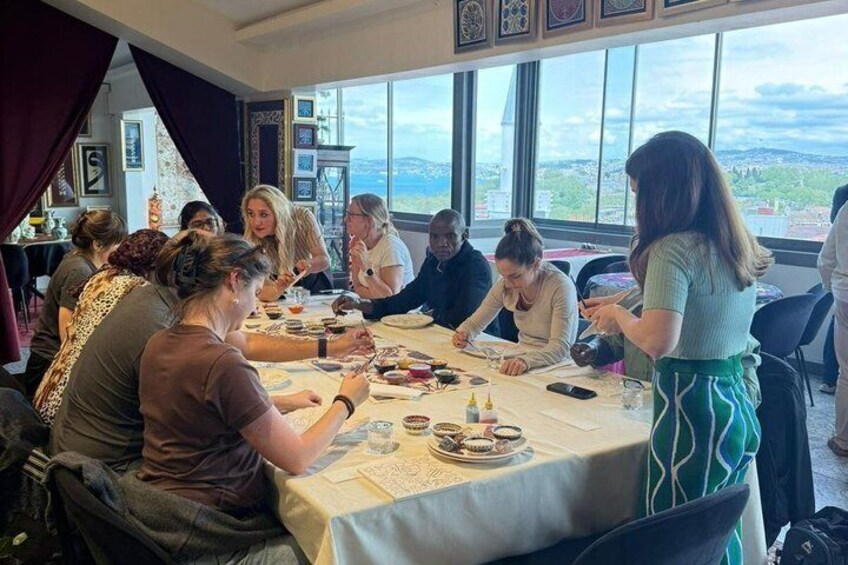 A group of people dining at a table with a view of the landscape. 3