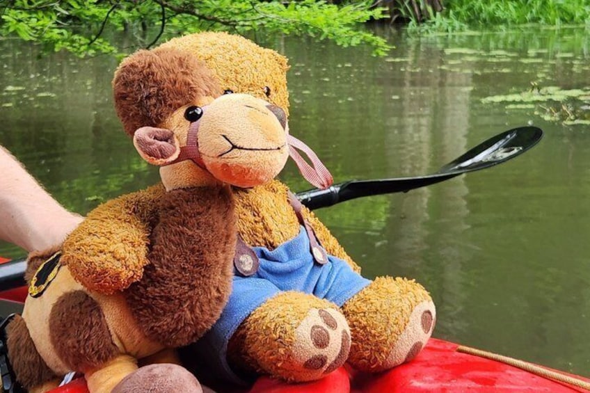 A plush monkey toy with a fishing rod on a red boat. 2