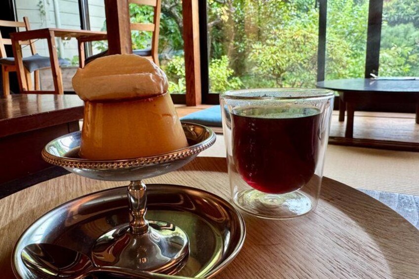 A dessert on a silver platter and a glass of red beverage on a wooden table. 2