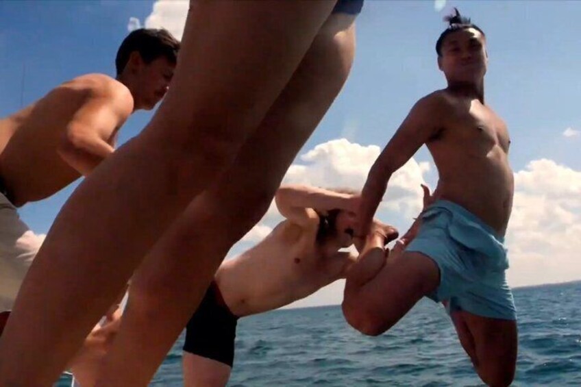 People on a boat, water, and a clear sky. 2