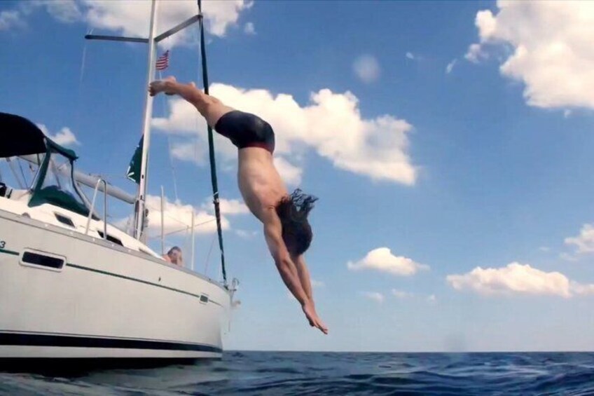 A person diving into the ocean from a boat. 4