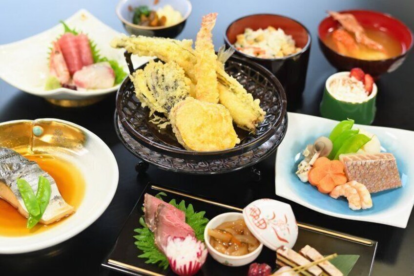 A variety of Japanese dishes including tempura, sashimi, and sushi. 4