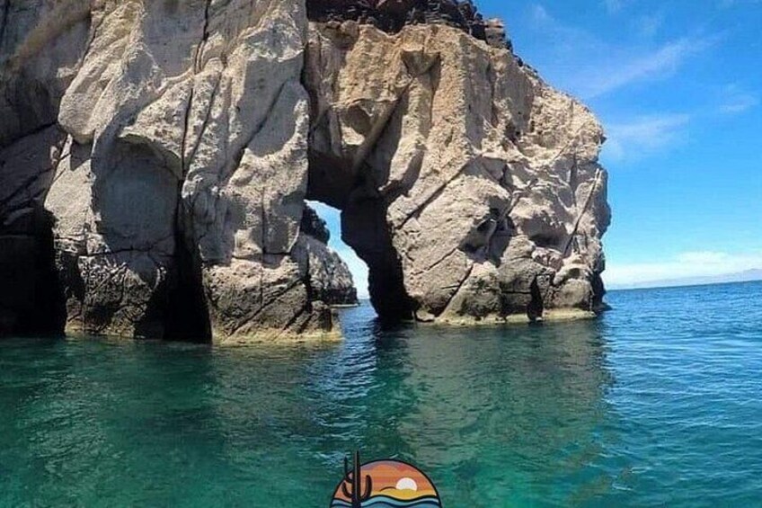A rocky coastline with a natural arch formation. 2