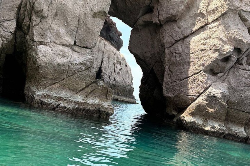 A natural rock formation with a narrow passage through it. 4