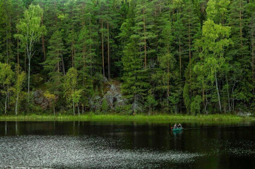 A calm lake surrounded by dense forest. 2