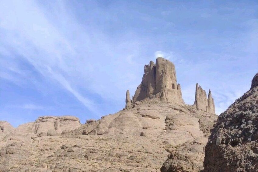A desert landscape with prominent rock formations and a clear sky. 5
