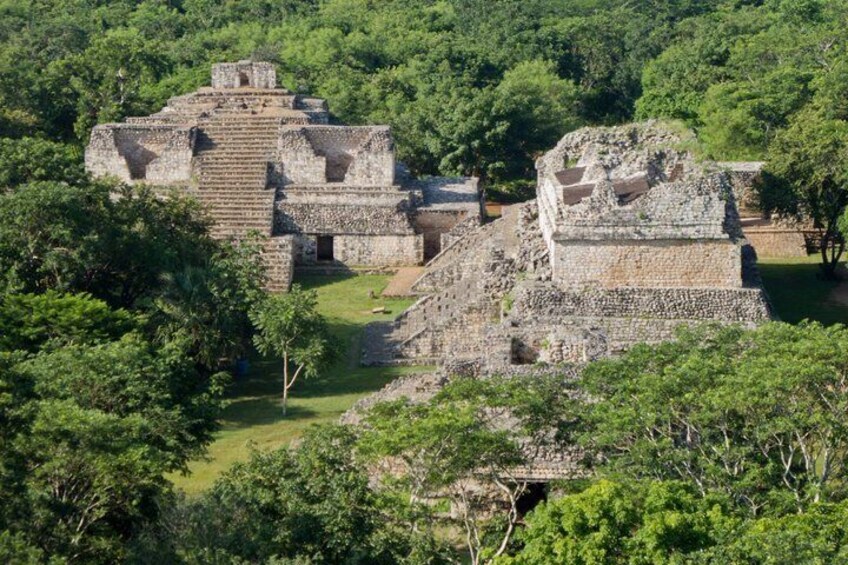 Ancient stone ruins surrounded by dense green forest. 3