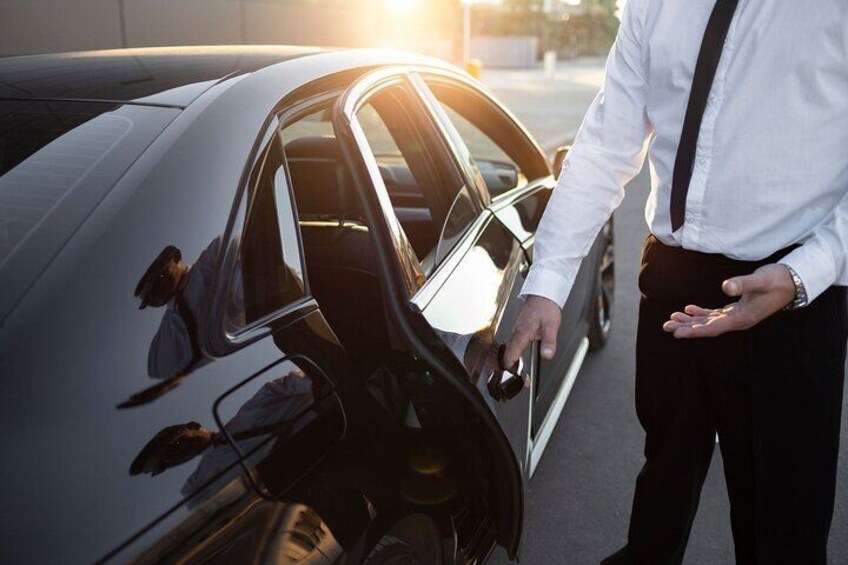 A person opening a car door. 2
