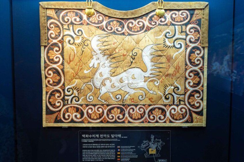 A decorative panel with a white horse and intricate designs. 3