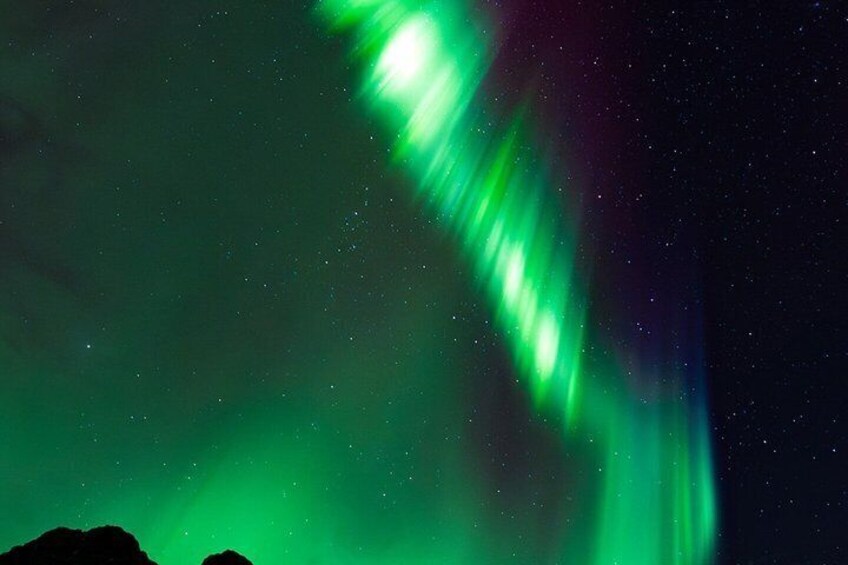 The Northern Lights (Aurora Borealis) in a night sky. 3