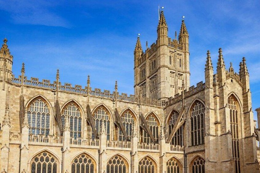 A historic building with Gothic architecture, featuring pointed arches and a large tower. 2