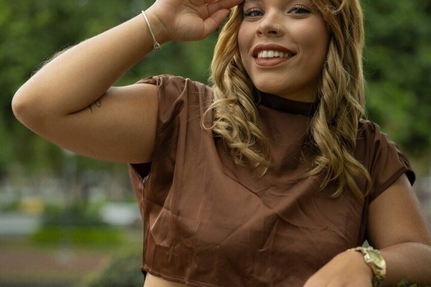 A person wearing a brown top, with a bracelet on the left wrist. 5