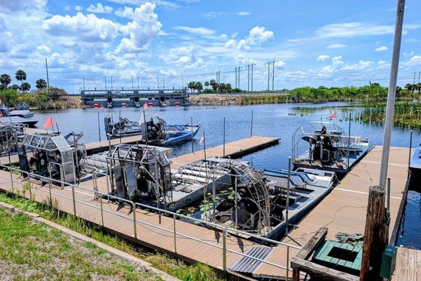 A dock with boats, a bridge in the background, and a clear sky. 3