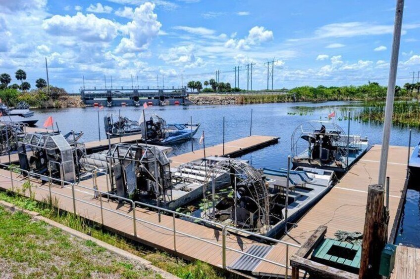 A lock system with boats, a bridge, and a riverbank. 4