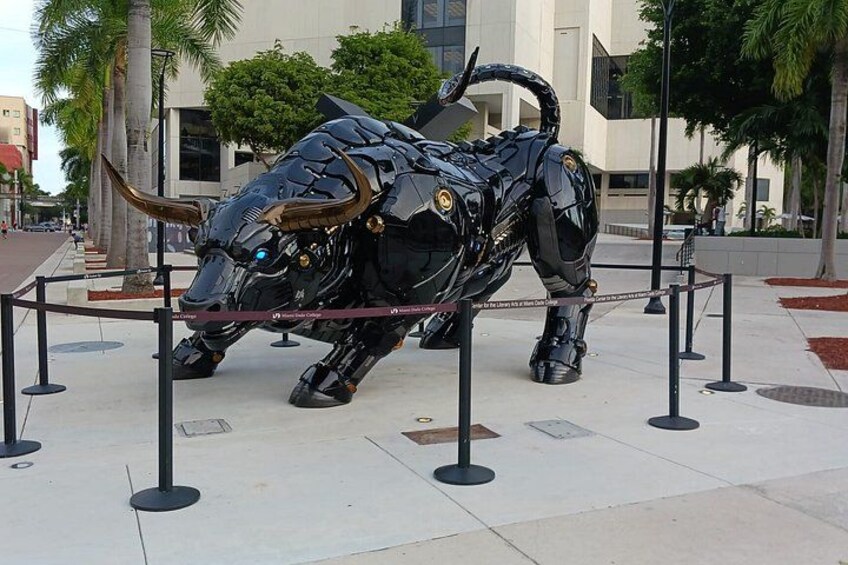 A large mechanical bull sculpture in an urban plaza. 5
