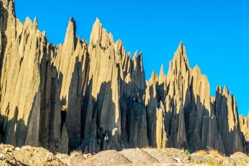A rugged mountain range with sharp peaks under a clear blue sky. 4